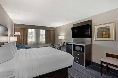 a hotel room with a bed and a flat screen tv at Best Western Plus Reading Inn & Suites in Reading