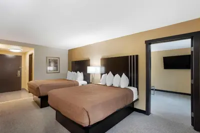 a hotel room with two beds and a flat screen tv at Best Western Plus Reading Inn & Suites in Reading