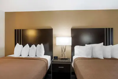 two beds in a hotel room with white pillows at Best Western Plus Reading Inn & Suites in Reading