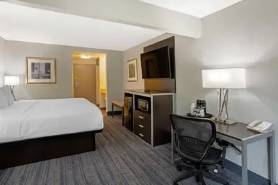 a hotel room with a bed and a desk with a computer at Best Western Plus Reading Inn & Suites in Reading