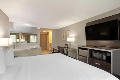 a hotel room with a bed and a bathroom at Best Western Plus Reading Inn & Suites in Reading