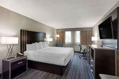 a hotel room with a bed and a desk at Best Western Plus Reading Inn & Suites in Reading