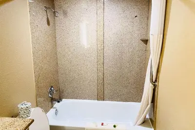 a bathroom with a tub and a toilet and a shower at Super 8 by Wyndham Danville in Danville