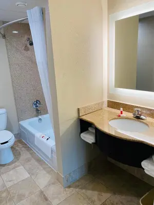 a bathroom with a sink and a tub and a toilet at Super 8 by Wyndham Danville in Danville