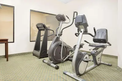 two exercise bikes in a room with a mirror at Super 8 by Wyndham Danville in Danville