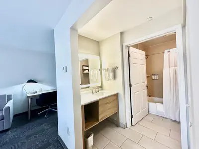 a bathroom with a sink and a desk at Staybridge Suites East Stroudsburg - Poconos by IHG in East Stroudsburg
