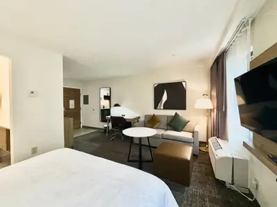 a hotel room with a bed and a couch at Staybridge Suites East Stroudsburg - Poconos by IHG in East Stroudsburg