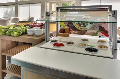 a display case with many different types of food at Element Ewing Princeton in Ewing