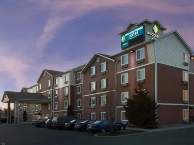 a large hotel with a sign on top of it at WoodSpring Suites Allentown Bethlehem in Bethlehem