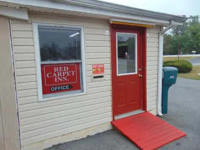 a red carport inn office with a red door at Red Carpet Inn Duncannon in New Buffalo