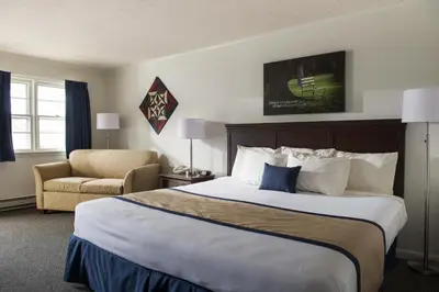 a hotel room with a large bed and a chair at Travelers Rest Motel in Intercourse