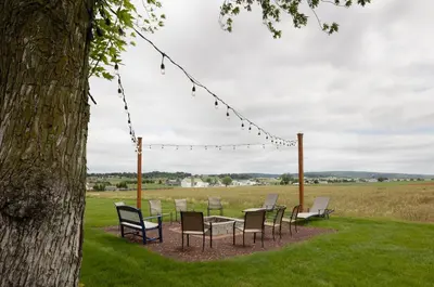 a group of chairs and a table under a tree at Travelers Rest Motel in Intercourse