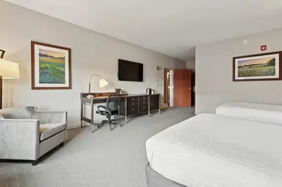 a hotel room with a bed and a desk and a chair at The Hotel Warner in West Chester