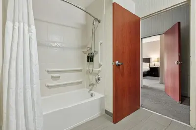 a bathroom with a shower and a bath tub at The Hotel Warner in West Chester