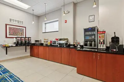 a restaurant with a counter with a coffee machine at The Hotel Warner in West Chester