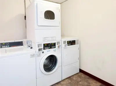 a laundry room with a washer and dryer at Days Inn by Wyndham Williamsport in Williamsport