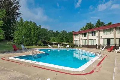 a large swimming pool in front of a building at Days Inn by Wyndham Williamsport in Williamsport