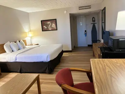 a hotel room with a bed and a television at Days Inn by Wyndham Williamsport in Williamsport