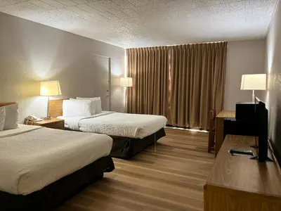 a hotel room with two beds and a window at Days Inn by Wyndham Williamsport in Williamsport