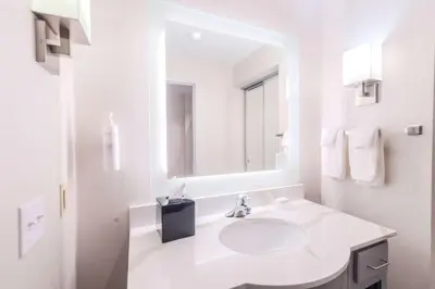 a white bathroom with a sink and a mirror at Homewood Suites - Doylestown in Warrington