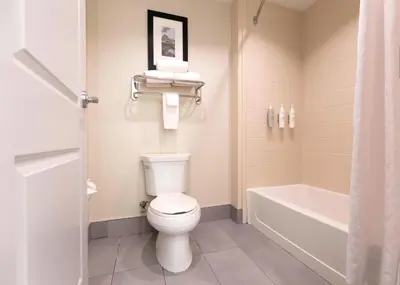 a bathroom with a toilet and a bath tub at Homewood Suites - Doylestown in Warrington