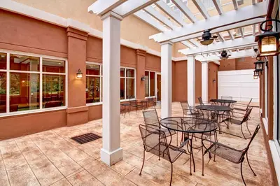 a patio with tables and chairs in a building at Homewood Suites - Doylestown in Warrington