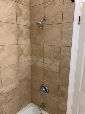 a shower with a shower head in a bathroom at Hill Top Motel in Wrightstown