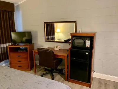 a room with a desk with a computer and a television at Hill Top Motel in Wrightstown