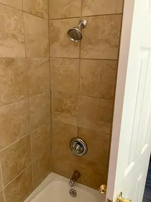 a bathroom with a shower with a bath tub at Hill Top Motel in Wrightstown
