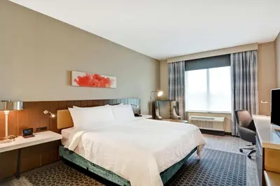 a hotel room with a bed and a desk at Hilton Garden Inn Princeton Lawrenceville in Lawrenceville