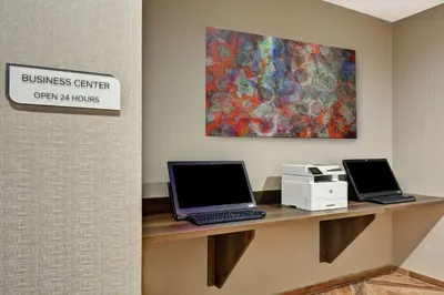 two laptops sitting on a desk in a room at Hilton Garden Inn Princeton Lawrenceville in Lawrenceville