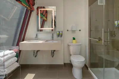 a bathroom with a toilet and a sink and a shower at Staypineapple, An Artful Hotel, Midtown New York in New York