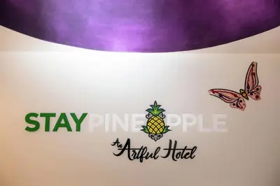 a sign for a pineapple hotel with a butterfly at Staypineapple, An Artful Hotel, Midtown New York in New York