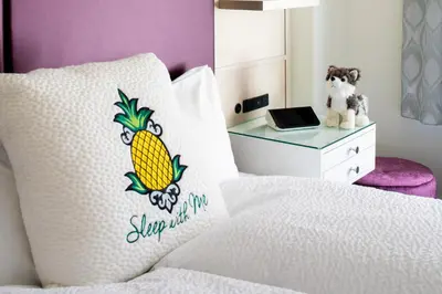 a bed with a pillow with a pineapple on it at Staypineapple, An Artful Hotel, Midtown New York in New York