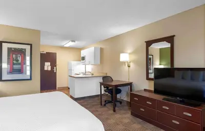 a hotel room with a bed and a desk and a kitchen at Extended Stay America Suites - Princeton - South Brunswick in South Brunswick Terrace