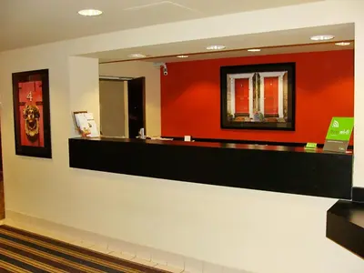 a hotel lobby with a mirror and red wall at Extended Stay America Suites - Princeton - South Brunswick in South Brunswick Terrace
