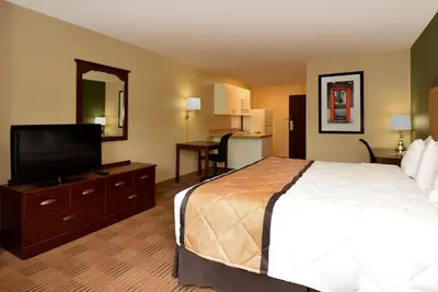 a hotel room with a bed and a flat screen tv at Extended Stay America Suites - Princeton - South Brunswick in South Brunswick Terrace