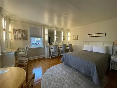 a bedroom with a bed and a table and chairs at Red Caboose Motel & Restaurant in Ronks
