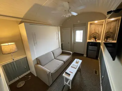 a living room with a couch and a table at Red Caboose Motel & Restaurant in Ronks