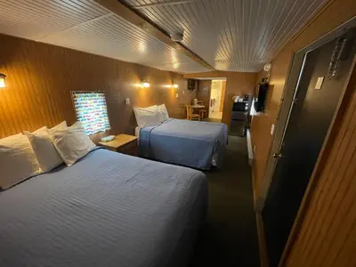 a hotel room with two beds and a window at Red Caboose Motel & Restaurant in Ronks