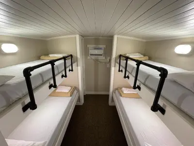 a room with three bunk beds in it at Red Caboose Motel & Restaurant in Ronks