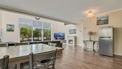 a large dining room with a table and a refrigerator at The Best Views From Camelback in Tannersville