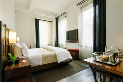 a hotel room with a bed and a television at Refinery Hotel - New York in New York