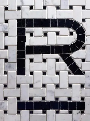 a black and white tiled floor with a swirl in the middle at Refinery Hotel - New York in New York
