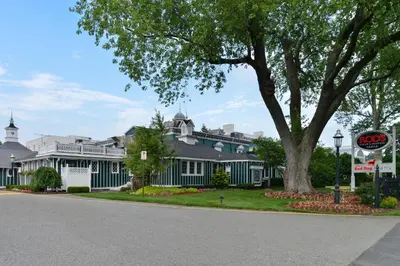 a large blue house with a tree in front of it at The Madison Hotel in Morristown