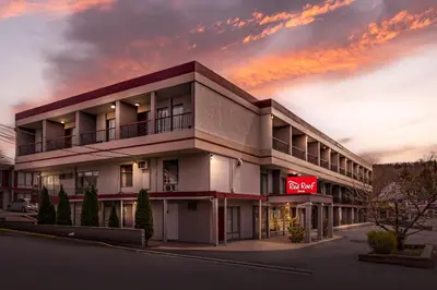 a building with a neon sign in front of it at Red Roof Inn Stroudsburg in Stroudsburg