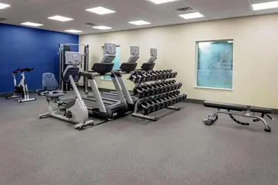 a gym with treadmills and elliptical machines at Hampton Inn Cranbury in Cranbury