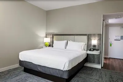 a large bed in a hotel room with two lamps at Hampton Inn Cranbury in Cranbury