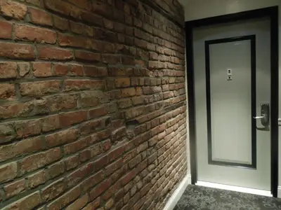 an entrance to a brick wall with a door at East Village Hotel in New York