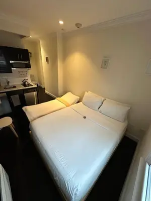 a large white bed in a small room at East Village Hotel in New York